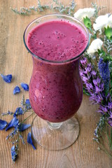 Purple smoothie with blue and white flower