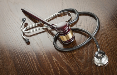 Gavel and Stethoscope on Reflective Table