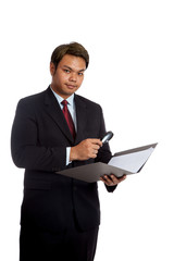 Asian businessman check data with magnifying glass