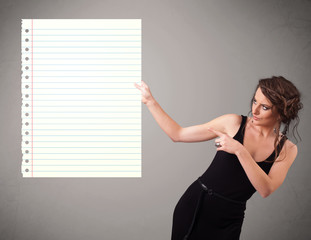 Young woman holding white paper copy space with diagonal lines