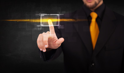 Tech business person touching button with orange light beams con