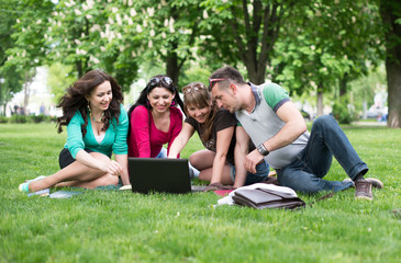 Four university students comparing their notes