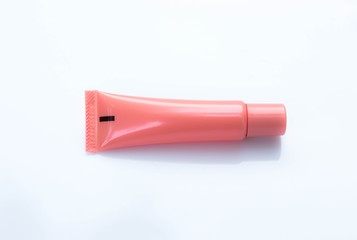 Tube cream pink on white background