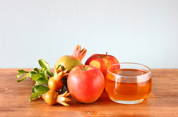 rosh hashanah concept - apple honey and pomegranate over wooden 