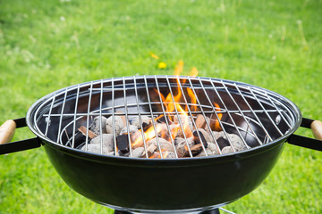 Empty burning grill on garden