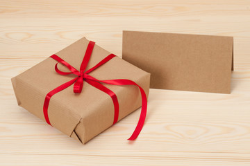 Gift Box And Card On Wooden Background