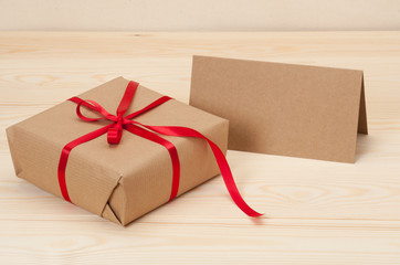Gift Box And Card On Wooden Background