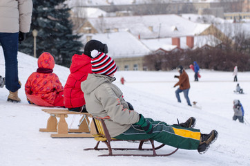 children sit wooden sledge ready slide from hill