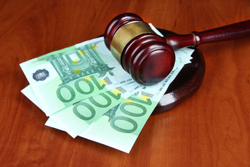 Gavel and money on table close-up