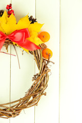 Beautiful Thanksgiving wreath, on white wooden background