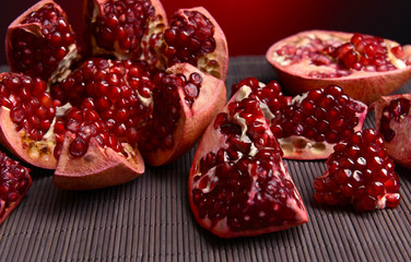 Ripe pomegranates on table close-up