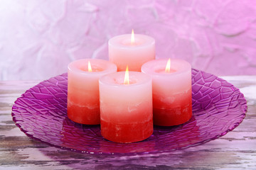 Beautiful candles on table on grey background