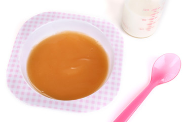 Baby food and milk isolated on white