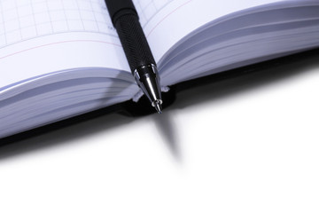 Pen on opened book, close up