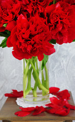Beautiful pink peonies in vase on wooden table