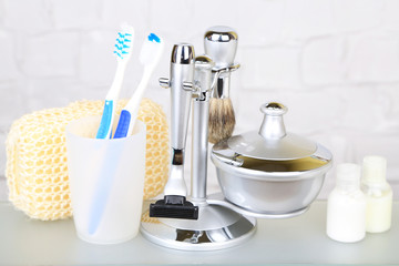 Male luxury shaving kit on shelf in bathroom