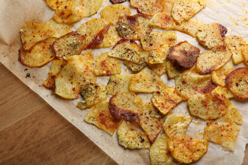 Homemade potato chips on wooden table