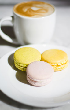 Plate Full of Delicious Macaroons at a Bakery with a Cup of Coff