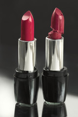 two red lipsticks, perfect versus imperfect symbolic concept ide