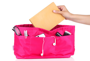 Pink cosmetic bag and female hand isolated on white