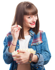 young woman eating popcorns on white background