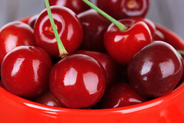 Sweet cherries in mug close up
