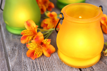 Bright icon-lamps with flowers on wooden background