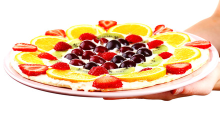 Homemade sweet pizza with fruits in hands isolated on white