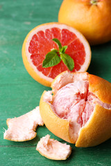 Ripe grapefruits on color wooden background