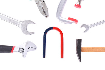 Composition of magnet and tools isolated on white