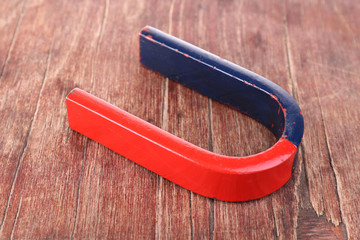 Magnet on color wooden background