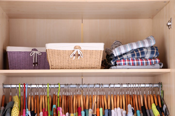 Colorful clothes hanging in wardrobe
