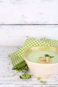 Tasty peas soup on wooden table