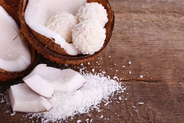 Broken coconut on wooden background