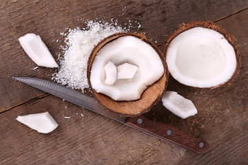 Broken coconut on wooden background