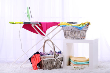 Baskets with laundry and ironing board