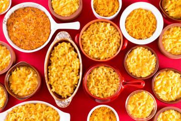 Several bowls of cheese macaroni served conceptually