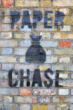 Paper chase. Painted on the brickswall