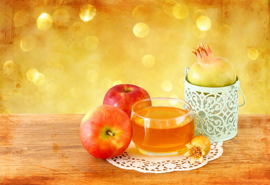 rosh hashanah concept - apple honey and pomegranate over wooden 