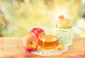 rosh hashanah concept - apple honey and pomegranate over wooden 