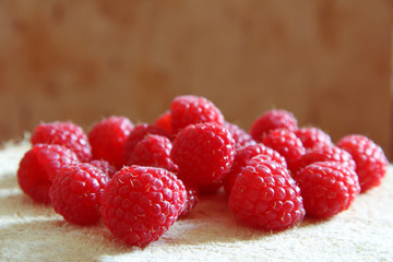 Fresh ripe raspberries on a wooden background