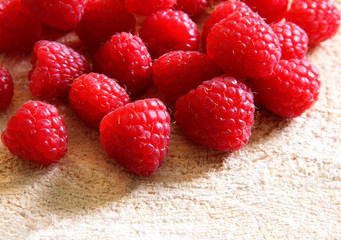 Fresh ripe raspberries on a wooden background