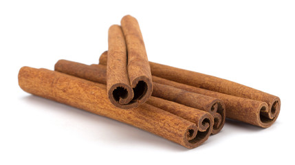 cinnamon sticks stacked on white background
