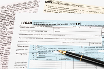 Tax form with pen taxation concept