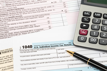 Fototapeta premium Tax form with pen and calculator taxation concept