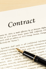 Business contract document on cream color paper with pen