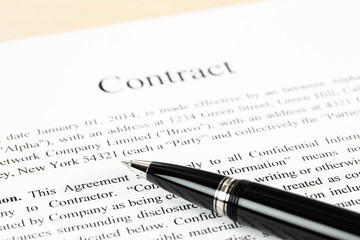 Business contract document focus at pen