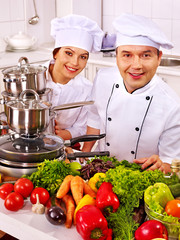 Man in chef hat cooking chicken