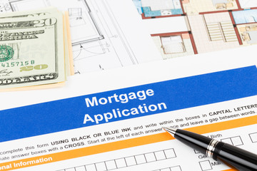 Mortgage application with pen, banknote, and drawing