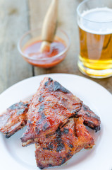 Spareribs on grill with hot marinade, czech beer